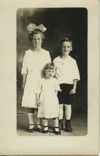 Three children, one big bow